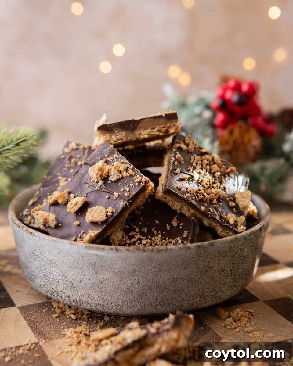 Bowl of graham cracker Christmas crack with chocolate and toffee layers