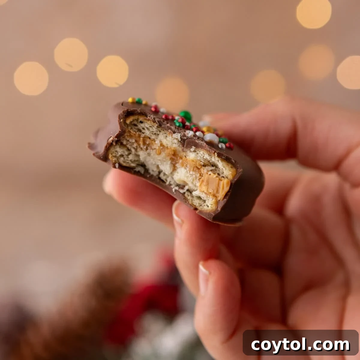 Easy No-Bake Ritz Peanut Butter Chocolate Sandwiches 2 Ritz peanut butter cookies with a bite taken out showing creamy peanut butter filling