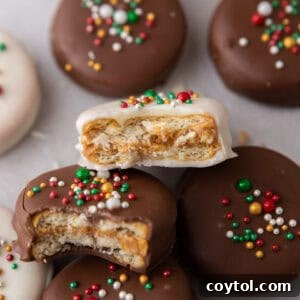 Easy No-Bake Ritz Peanut Butter Chocolate Sandwiches 11 A top-down shot of a tray of chocolate-dipped Ritz peanut butter cookies, some with sprinkles.