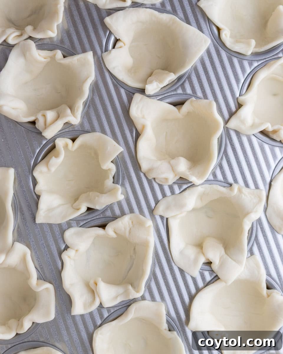 Sweet and Savory Brie Fig Pastry Bites 4 Squares of puff pastry gently pressed into a mini muffin tin to form the base of the cups.