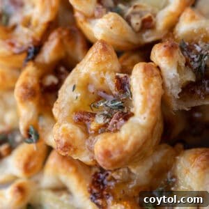 Beautifully baked Brie and Fig Jam Puff Pastry Cups, golden and flaky, ready to be served on a platter.