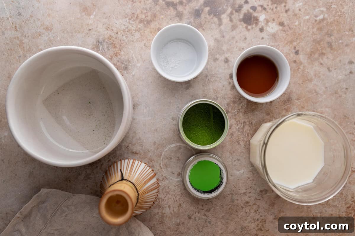 Velvety Salted Maple Matcha Frost 3 Ingredients for a salted maple matcha latte laid out on a counter