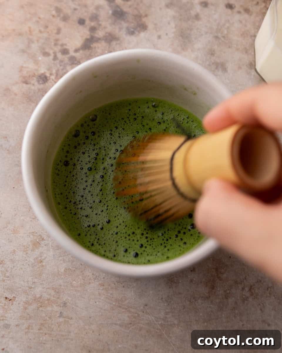 Velvety Salted Maple Matcha Frost 5 Whisked matcha being mixed until smooth and foamy
