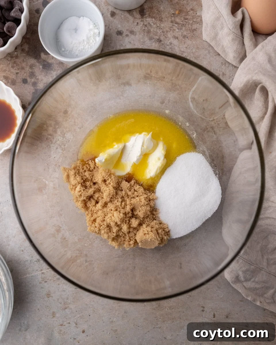 Butter, cream cheese, and sugars combined in a bowl for cream cheese chocolate chip cookies