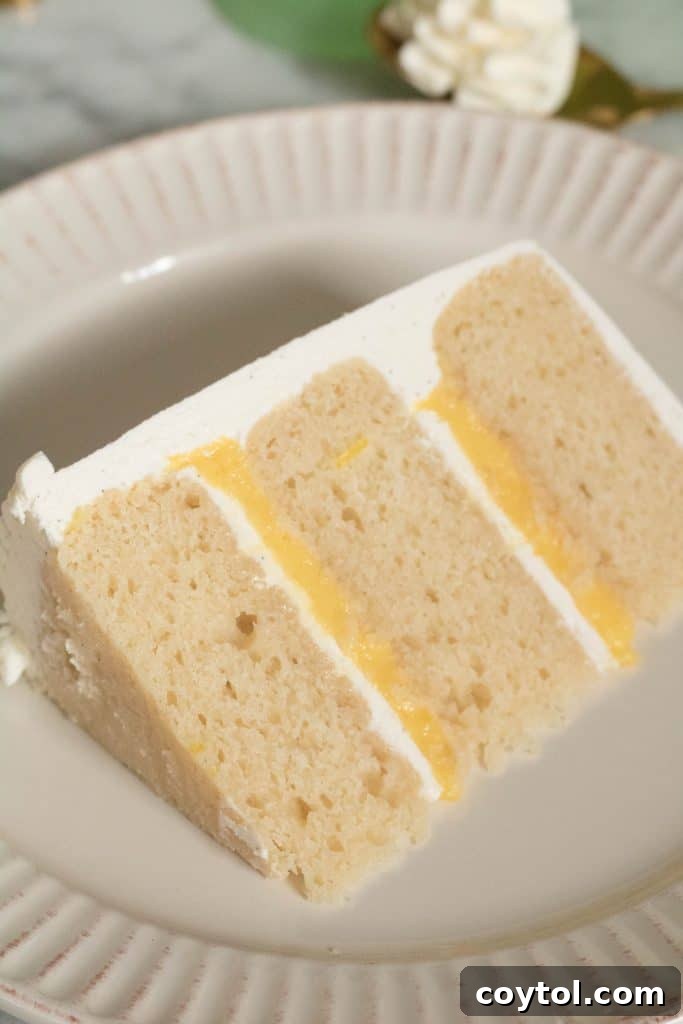 Layered vanilla cake with lemon curd and vanilla bean Italian meringue buttercream