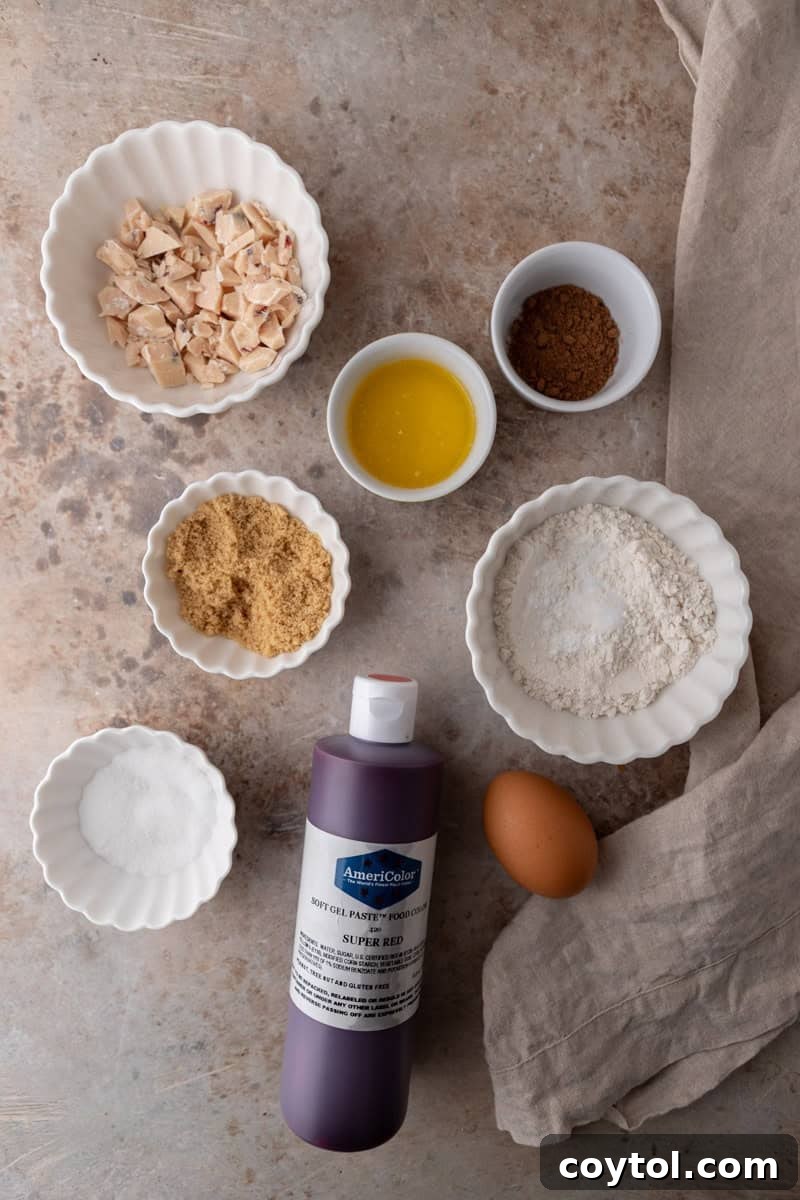 All the necessary ingredients for a single-serve red velvet cookie, neatly laid out on a kitchen countertop, ready for baking.