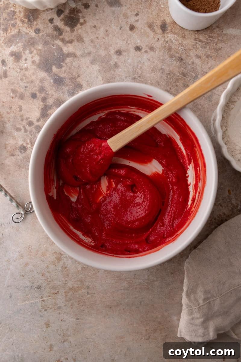 The red velvet cookie dough after the red food coloring has been incorporated, showcasing its rich, even color.