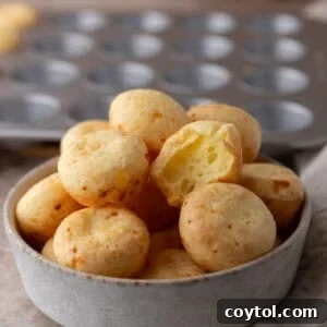 Brazilian cheese bread bites with a golden crust stacked in a bowl