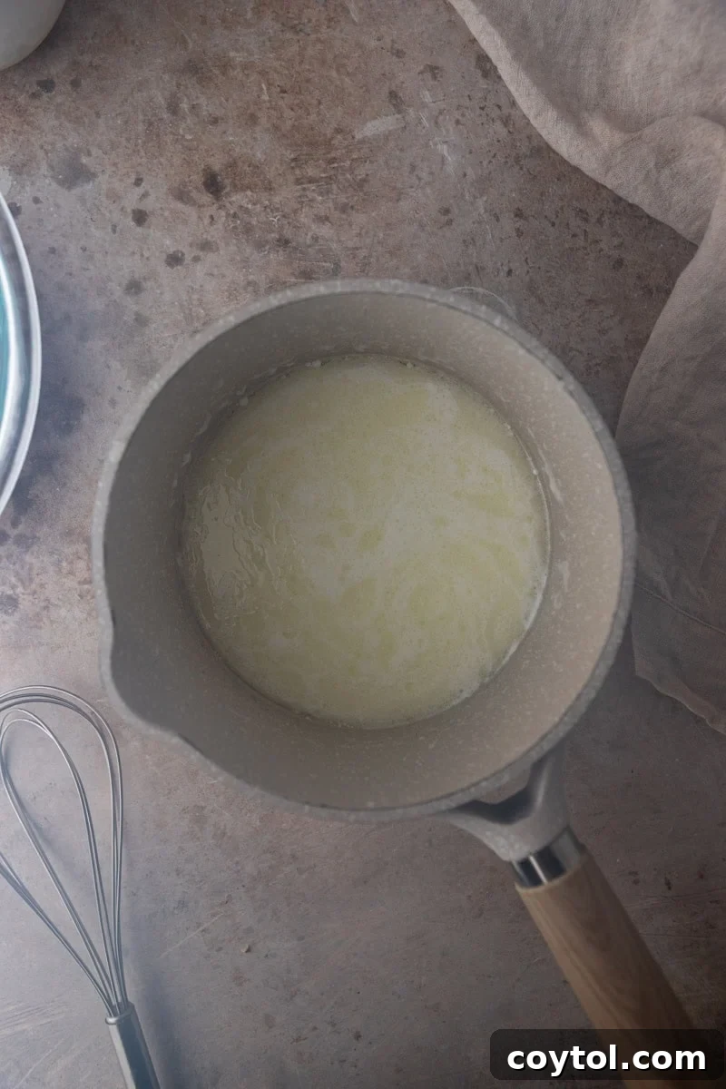 Milk and oil heating in a saucepan for pão de queijo dough