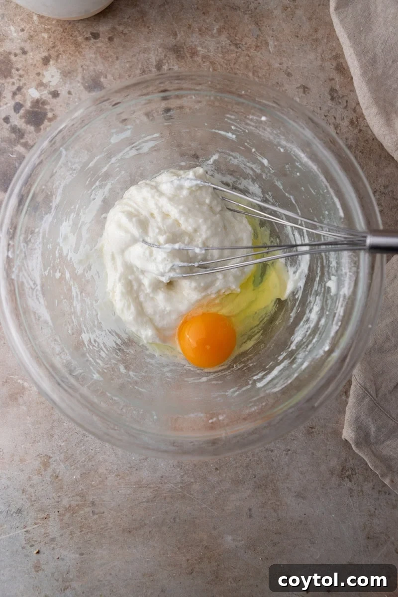 Egg added to warm tapioca dough for cheese bread batter