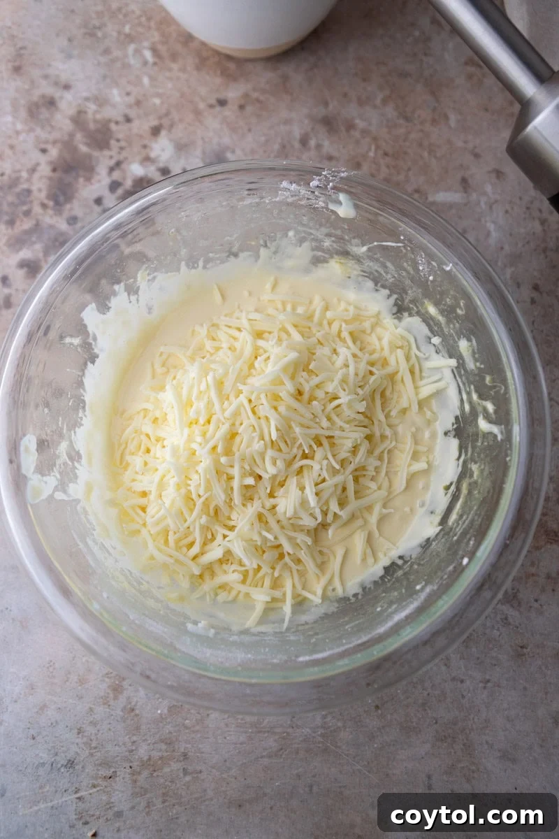 Grated cheese folded into cheese bread batter