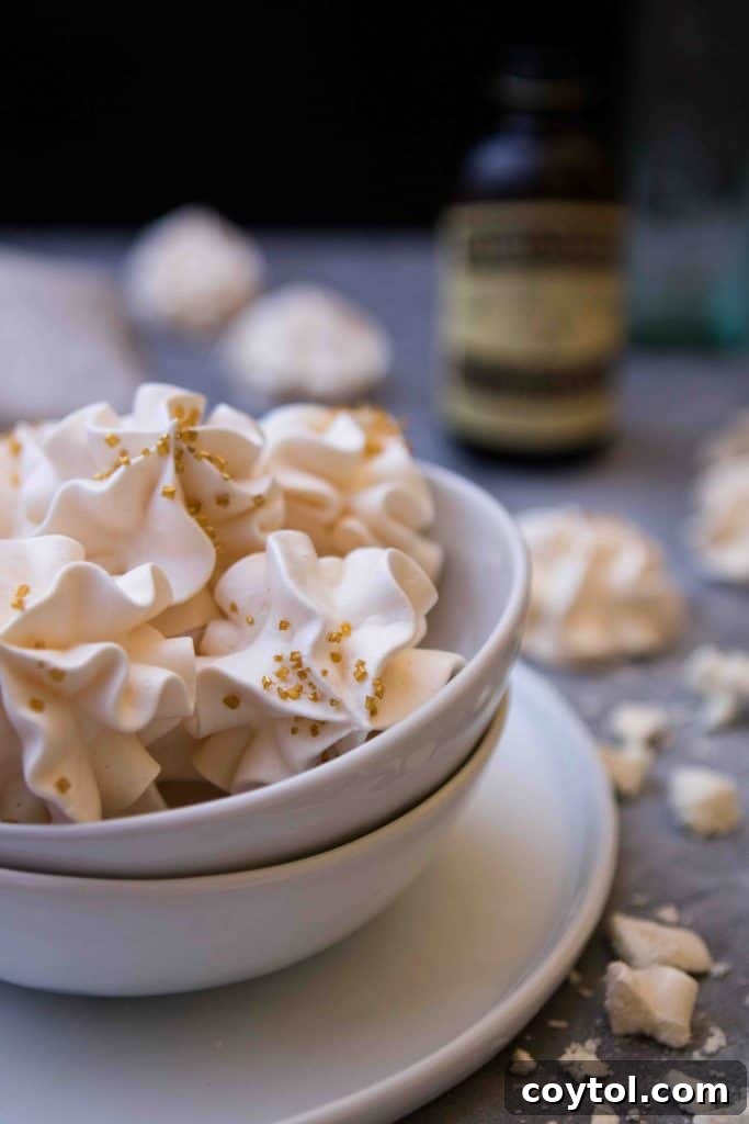 A tray of freshly baked, light and airy vanilla meringue cookies, perfect for Christmas.