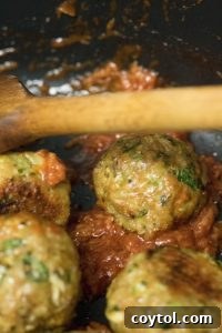 Glazed Indian Chicken Meatballs being tossed in a pan with the rich, aromatic sauce