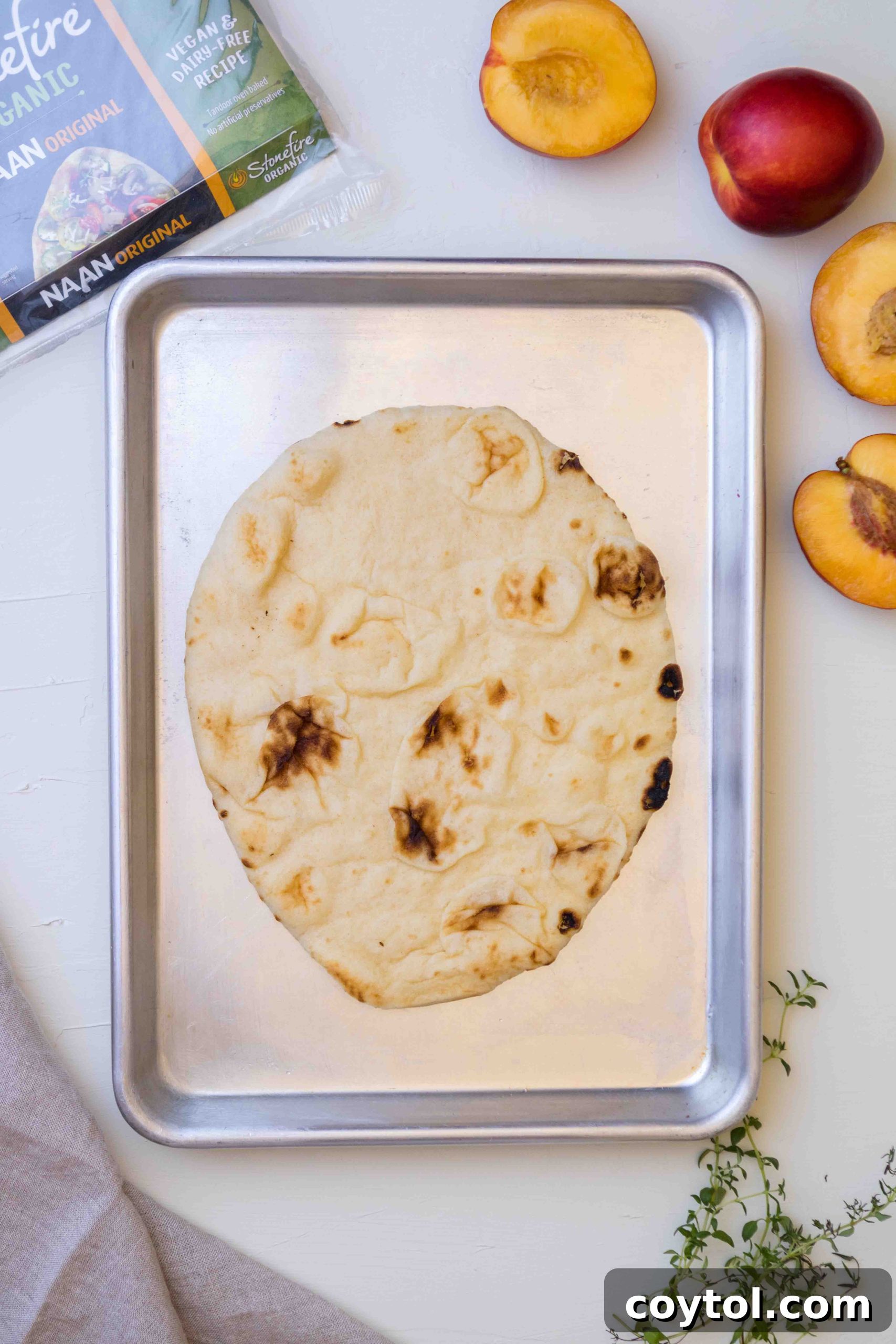 Preparing the flatbread for baking with ricotta cheese and nectarines