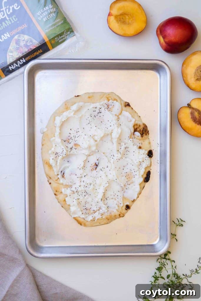 Spreading ricotta cheese on flatbread