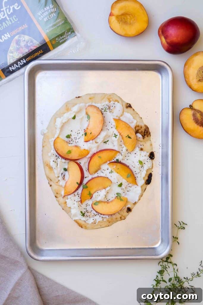 Adding sliced nectarines and fresh thyme to the flatbread