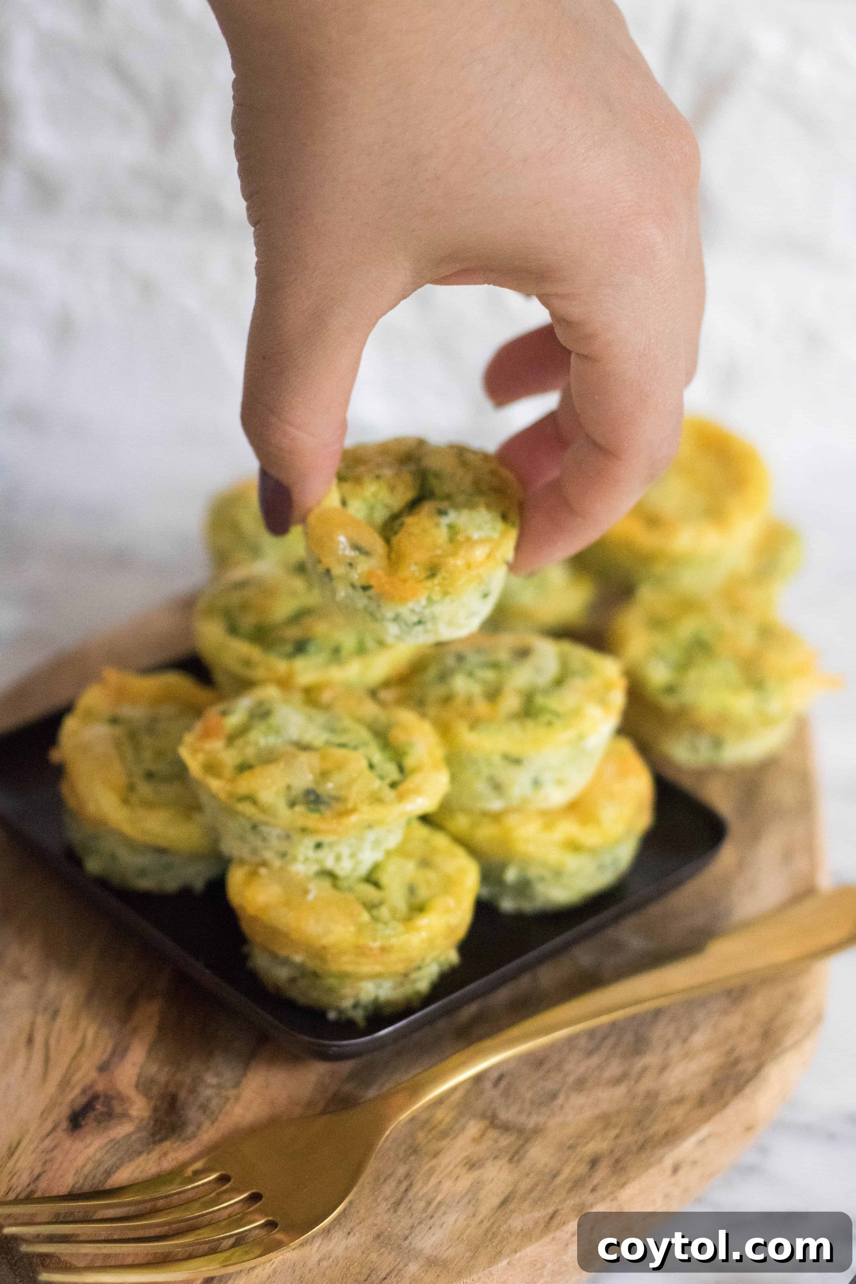 Close-up of baked Mini Breakfast Zucchini Frittatas, golden brown and garnished with herbs.
