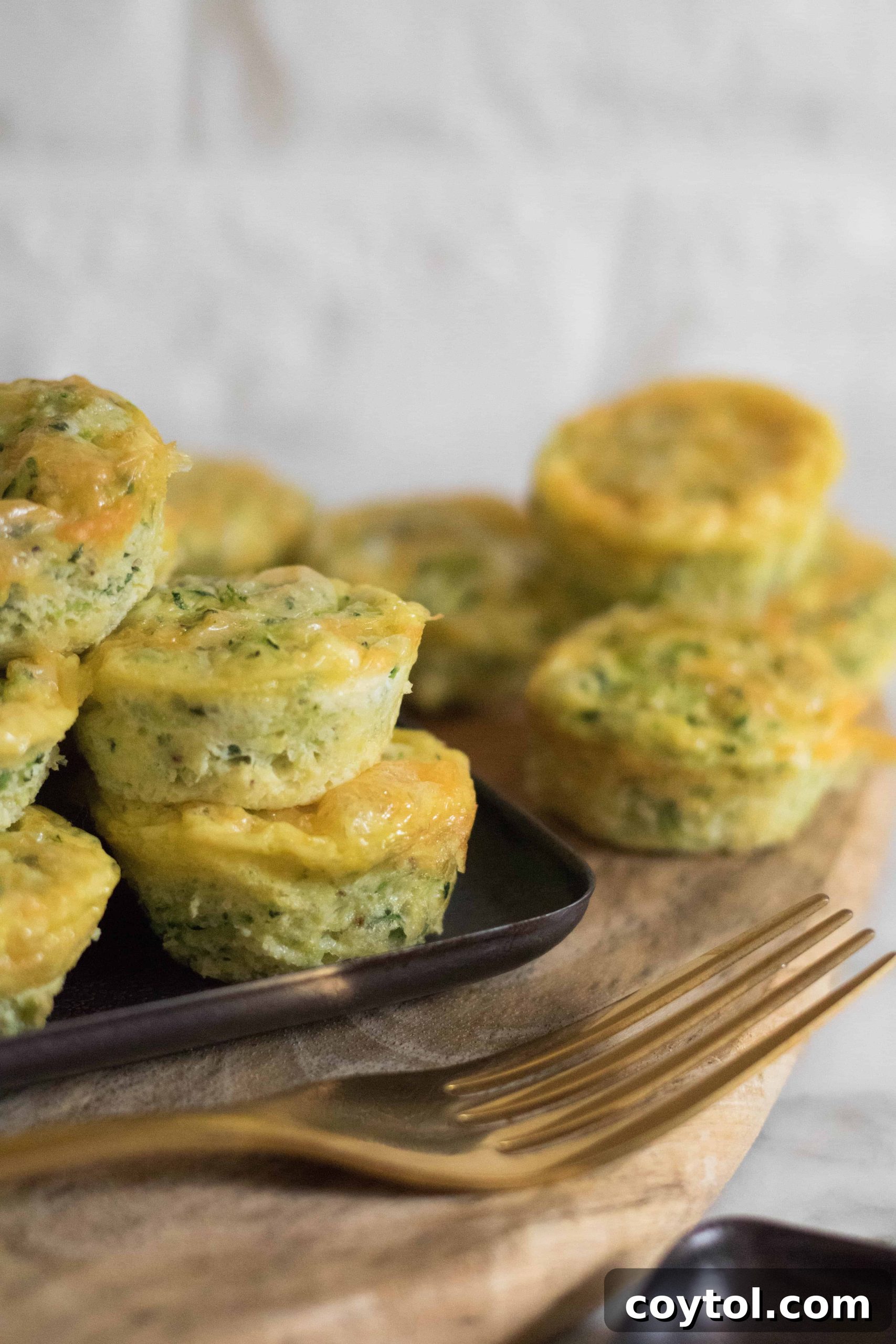 Appetizing close-up of a cooked Mini Breakfast Zucchini Frittata, showing its fluffy texture and cheesy topping.