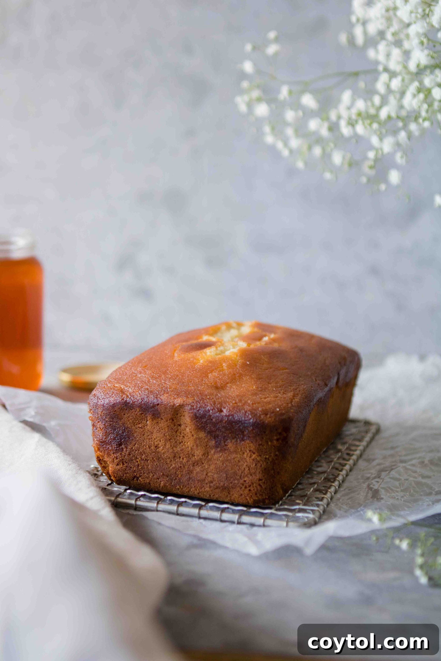 Grandma's Secret Moist Honey Tea Cake Loaf 2 Close-up of a perfectly baked Honey Tea Cake loaf, golden brown and drizzled with honey syrup