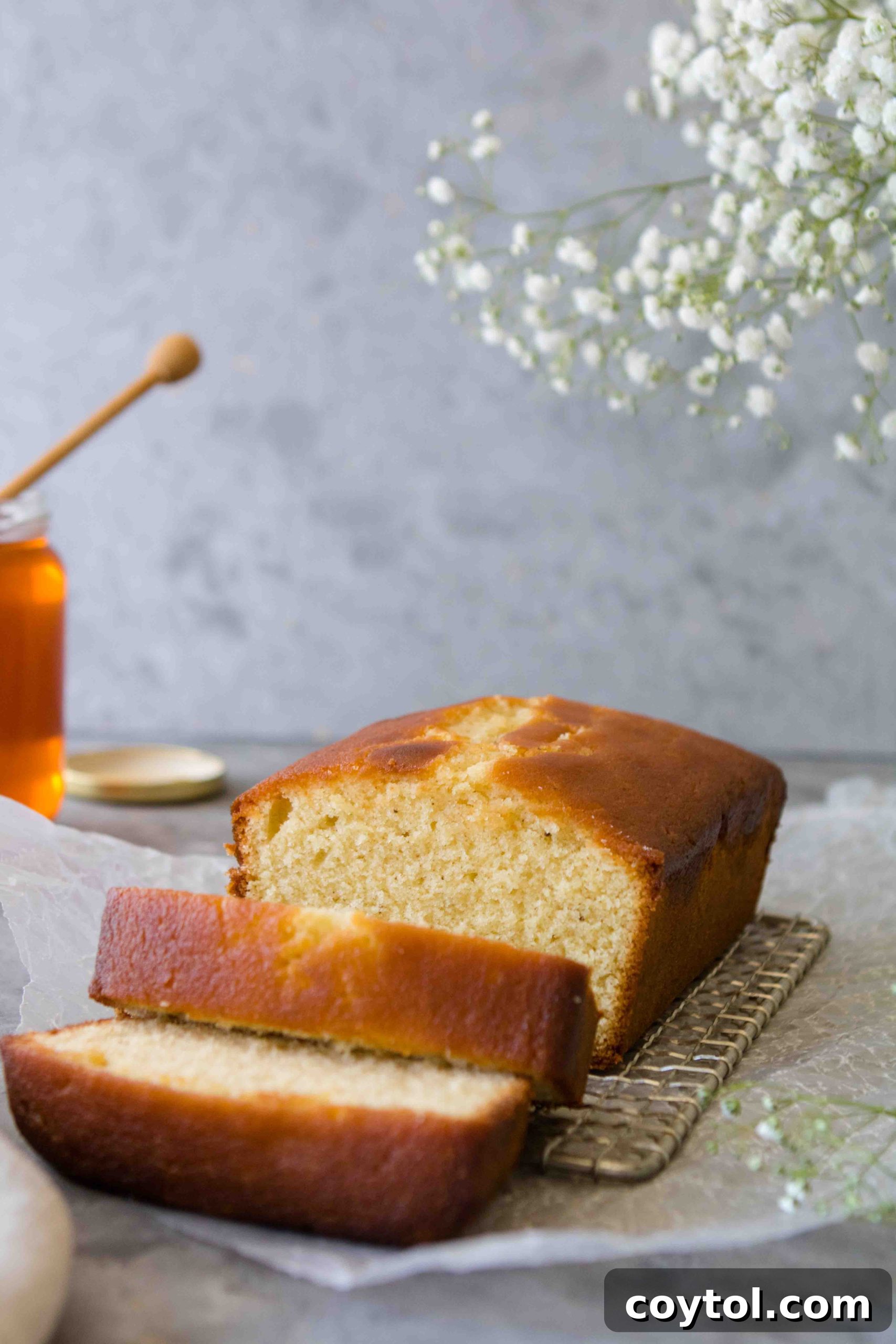 Grandma's Secret Moist Honey Tea Cake Loaf 4 A slice of Honey Loaf Cake with honey drizzle on top, highlighting its moist texture