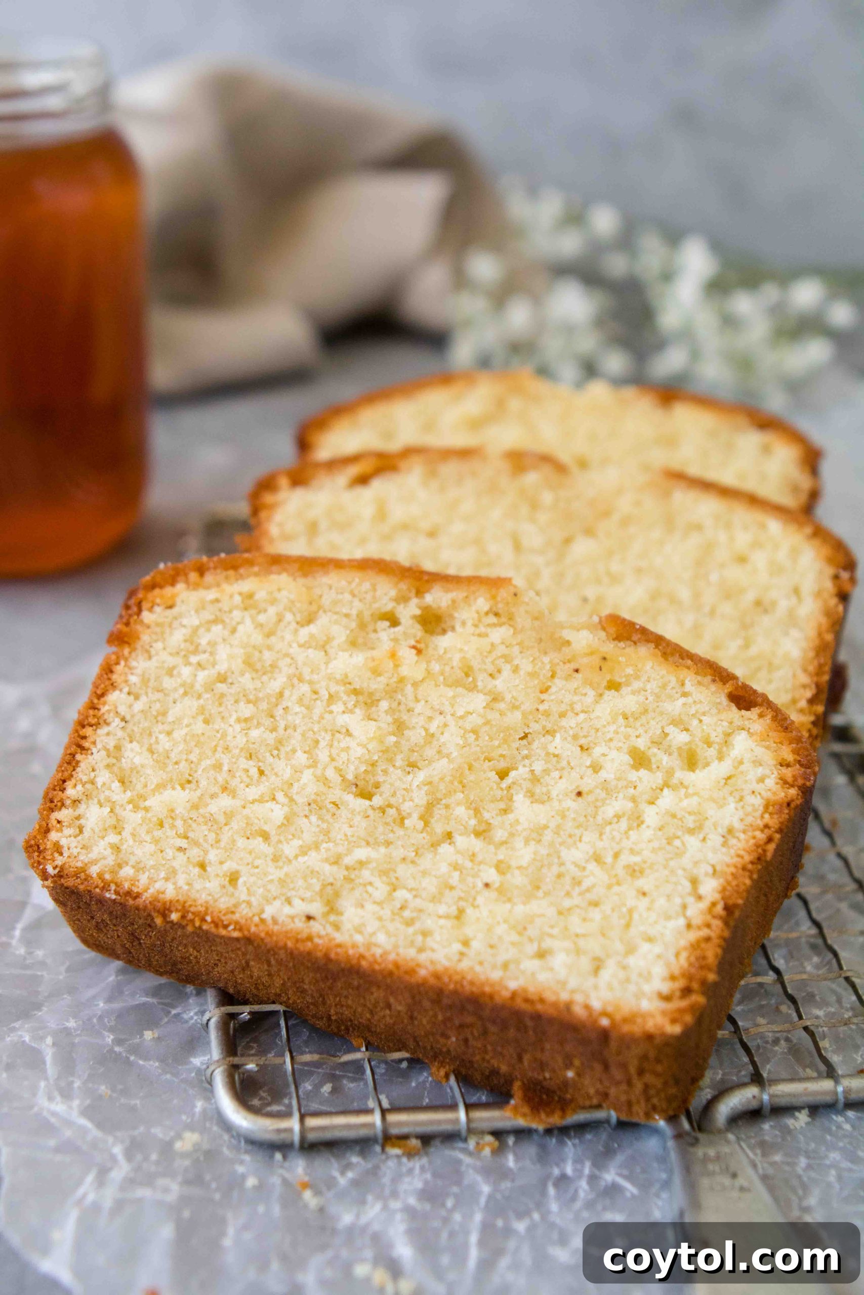 Grandma's Secret Moist Honey Tea Cake Loaf 5 Honey cake loaf being drizzled with honey syrup after baking