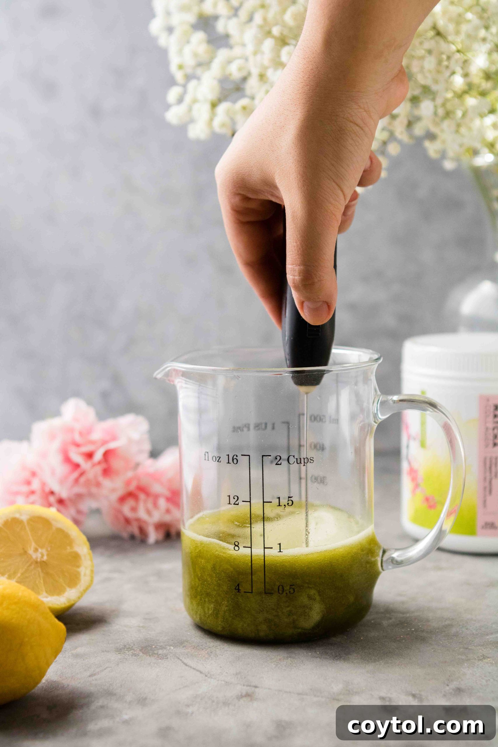Using a milk frother to mix matcha into syrup