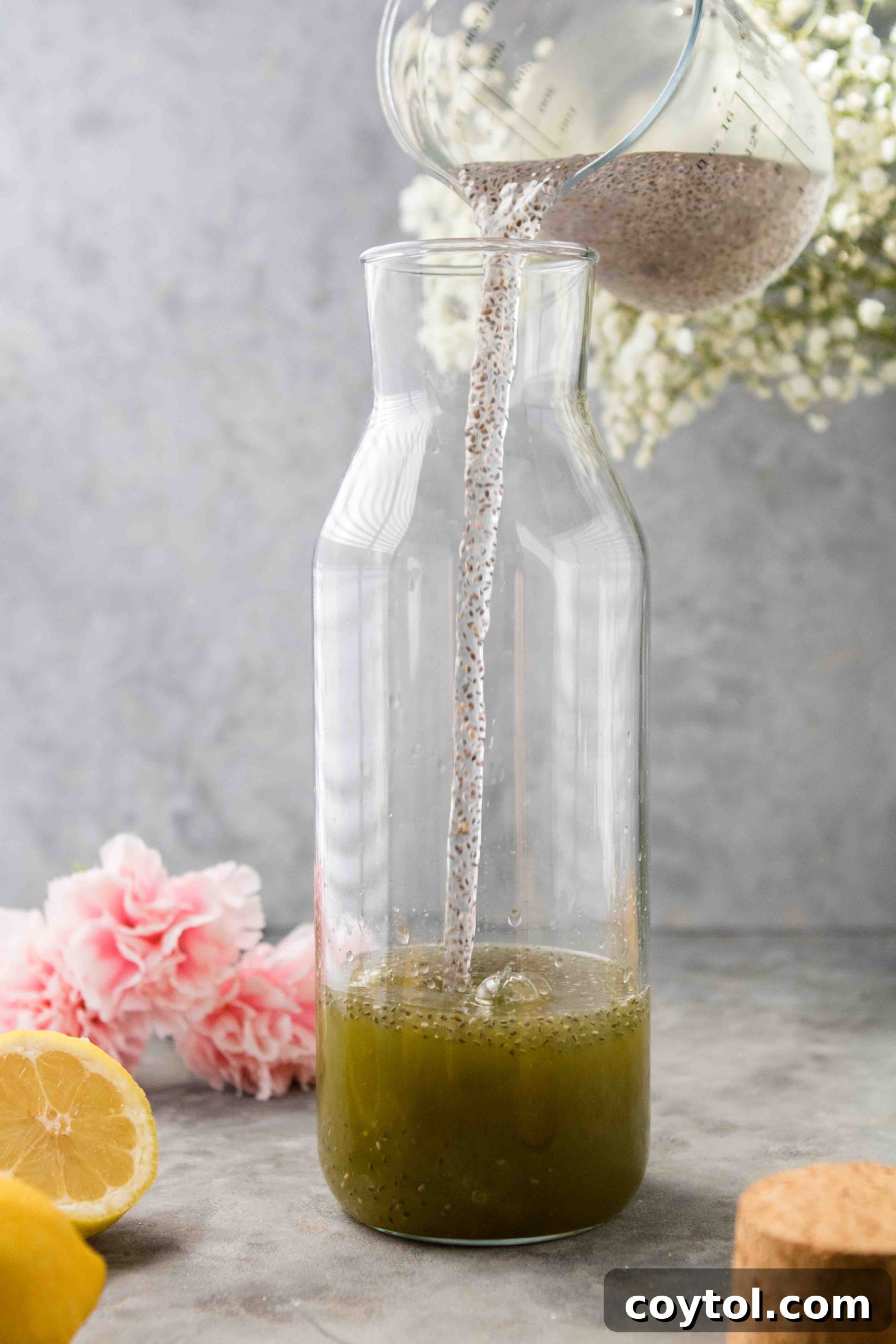 Finished matcha lemonade with chia seeds in a glass bottle