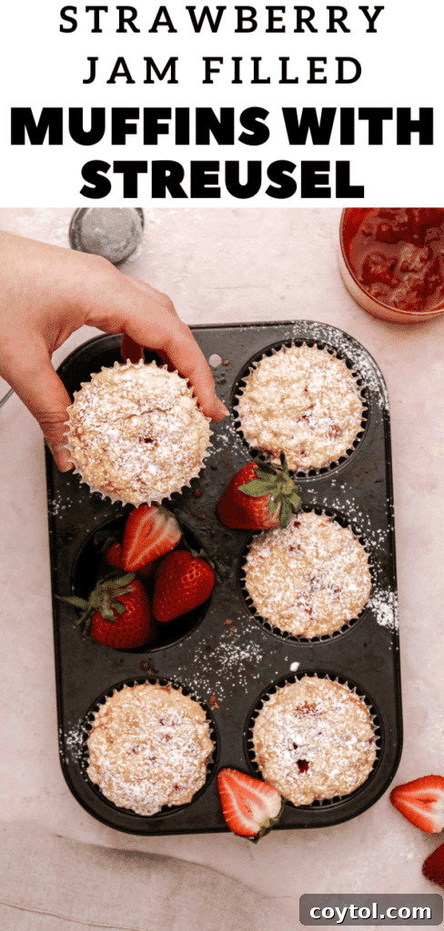 Delicious strawberry jam filled muffins with streusel topping, a perfect visual for pinning.