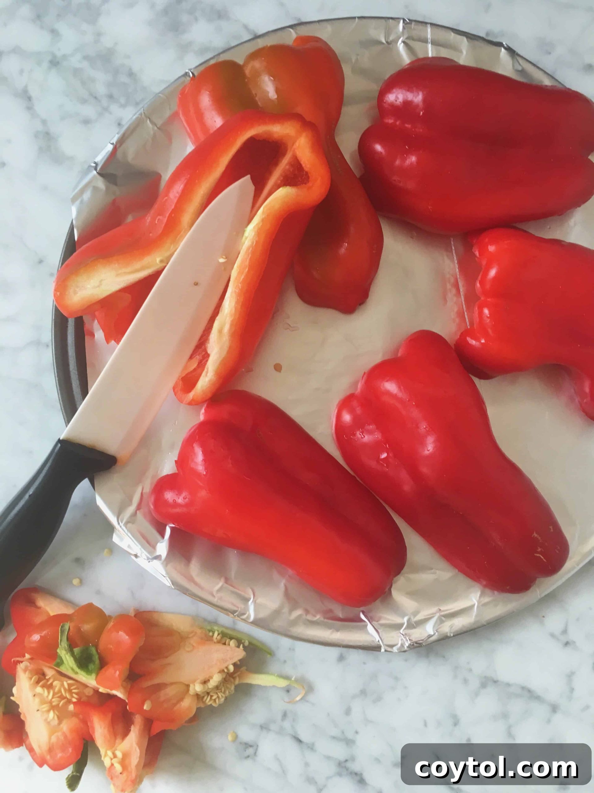 Red bell pepper cleaning process showing halves with seeds removed