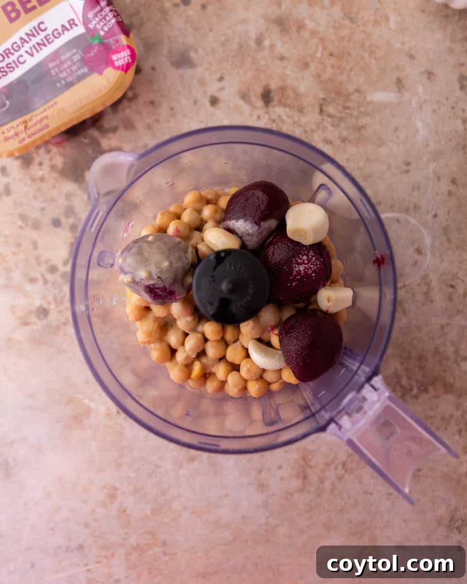 Food processor blending chickpeas and beets