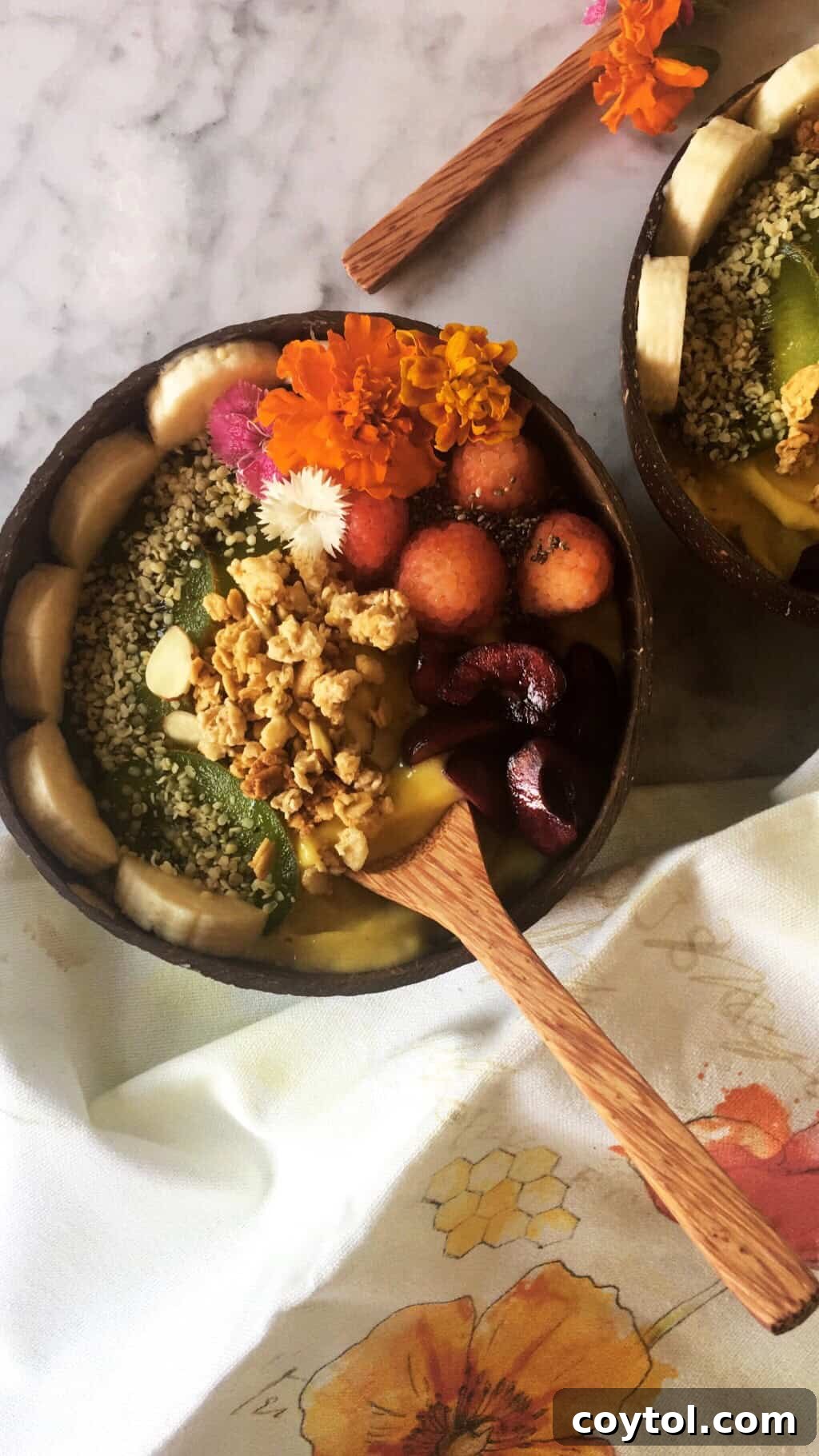 Mango Sunrise Smoothie Bowl 2 Delicious and healthy smoothie bowl topped with raspberries, kiwi, bananas, chia seeds, granola, and hemp seeds