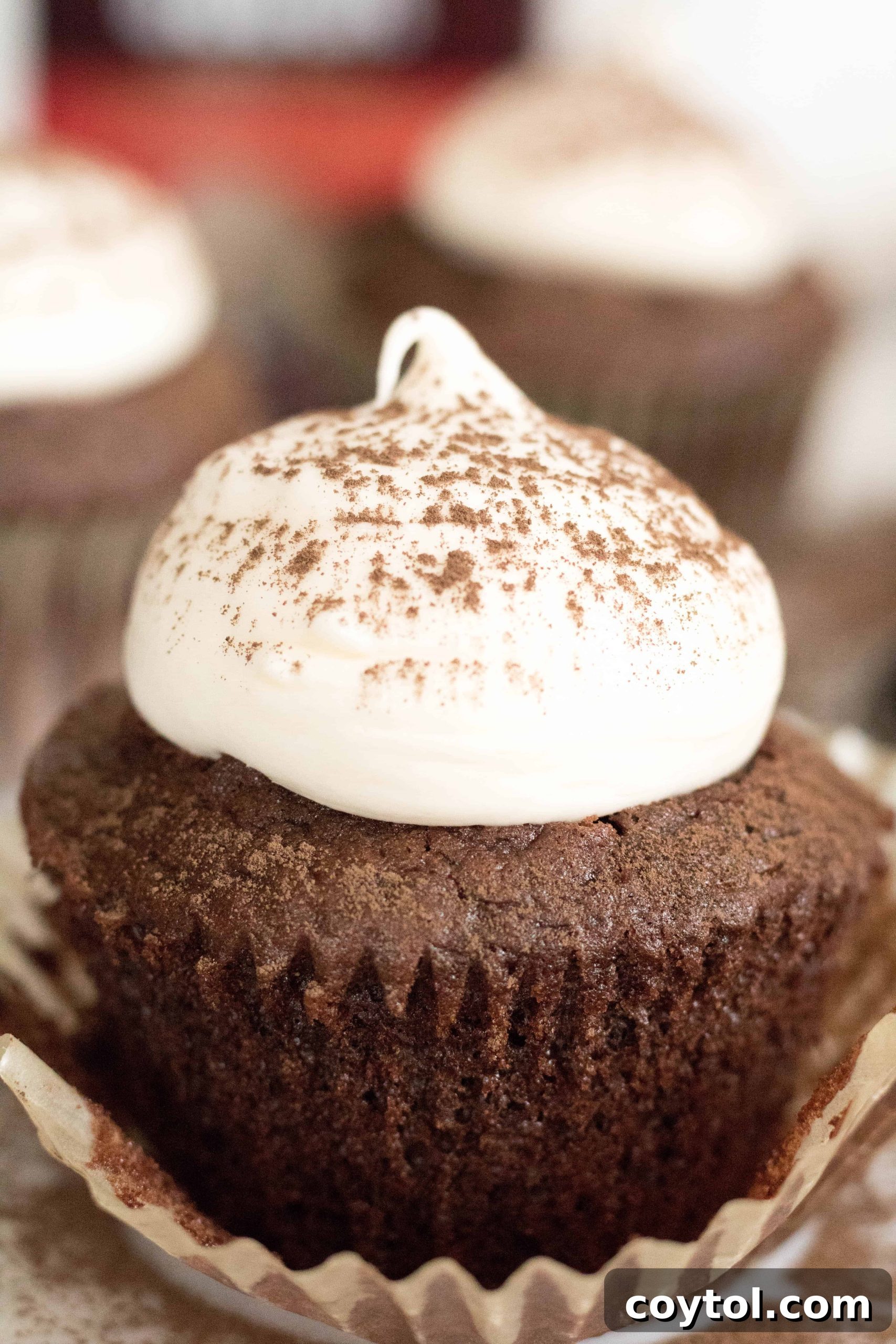 A delicious chocolate cupcake with a dollop of cream cheese frosting, showcasing perfect baking without eggs.