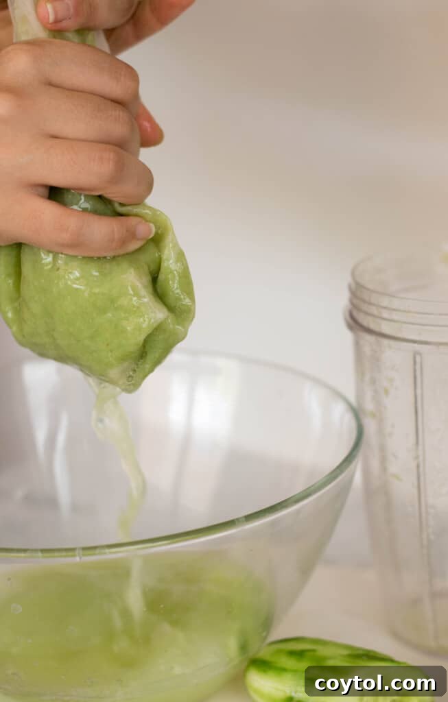 Squeezing grape juice from bag