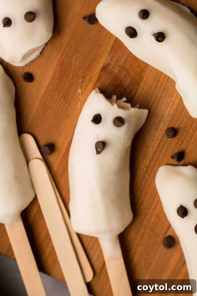 A cluster of beautifully arranged Boonanas, frozen banana ghosts, showcasing their playful and healthy appeal for Halloween.