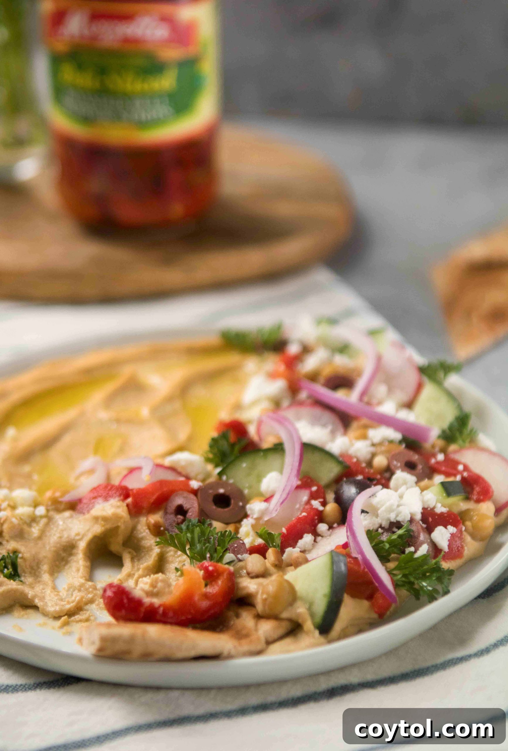 Close-up of Mediterranean loaded hummus with rich toppings