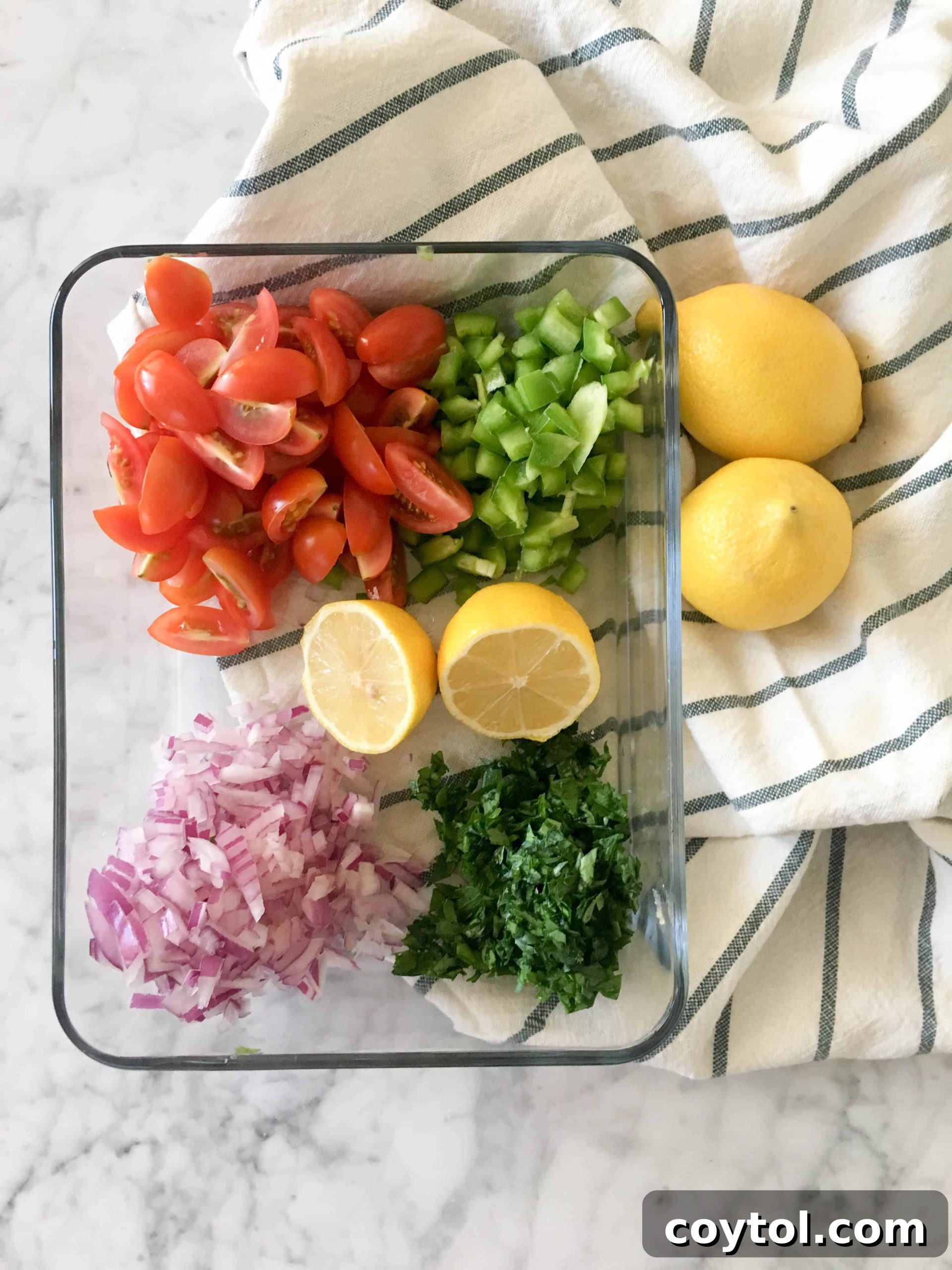 Prepared Fresh Ingredients for Quinoa Salad: Cherry Tomatoes, Italian Parsley, Green Bell Pepper, Red Onion, and Lemon