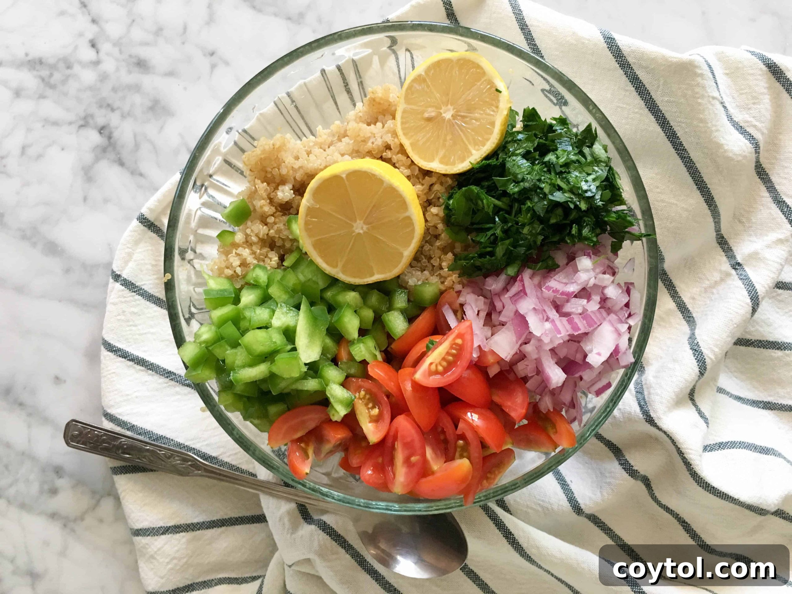 Mixing Quinoa Salad Ingredients in a Bowl