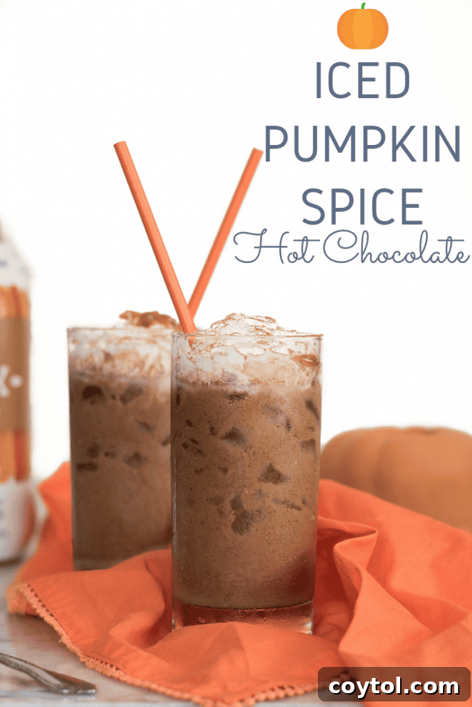 A close-up shot capturing the smooth, creamy texture and delicious layers of Iced Vegan Pumpkin Spice Hot Chocolate within a clear glass.
