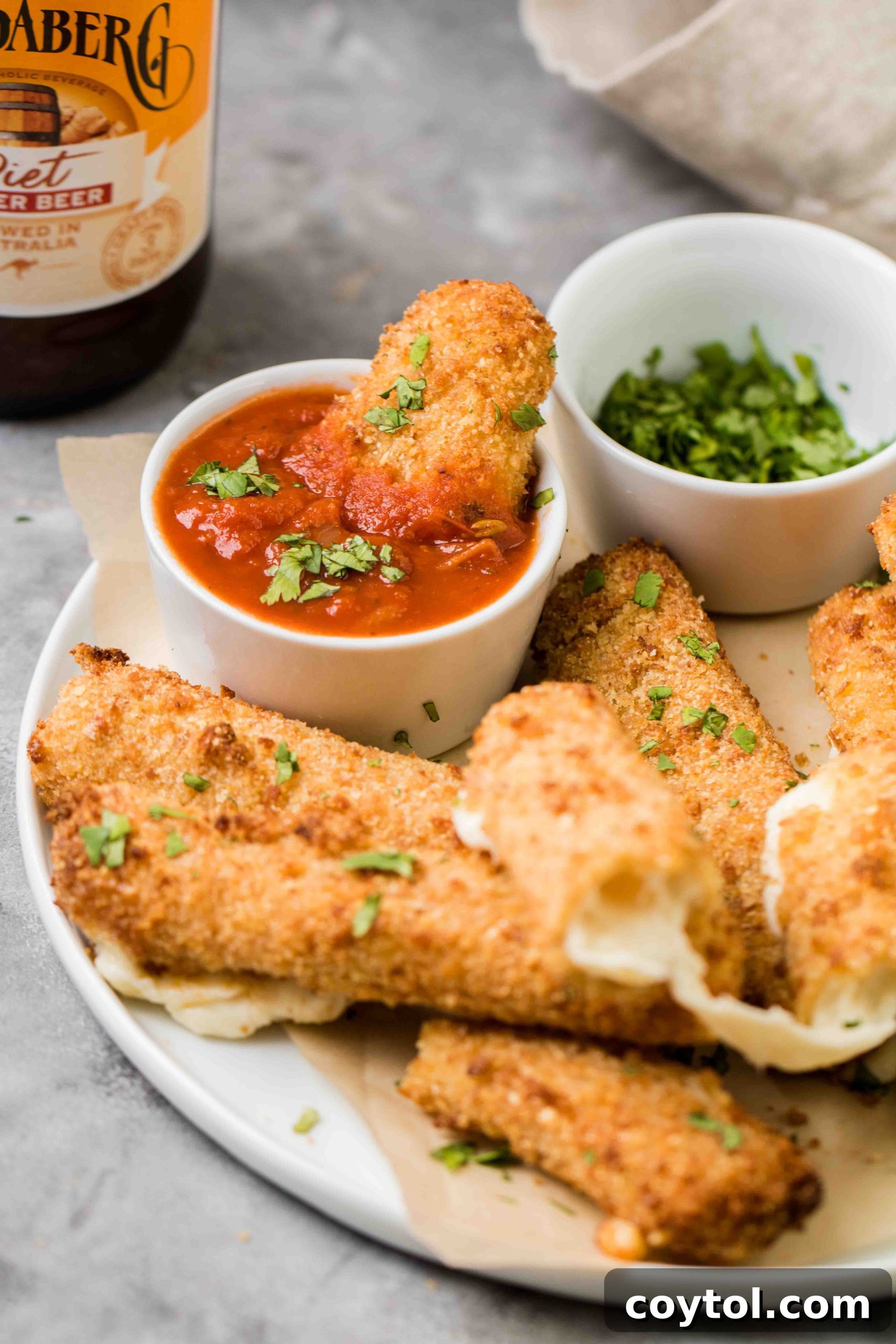 Air fryer mozzarella stick oozing with cheese