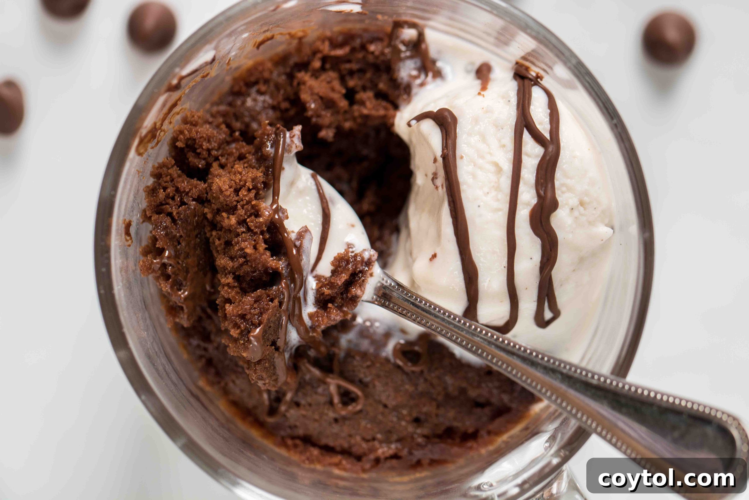 Half-eaten fudgy chocolate brownie mug cake with a spoon