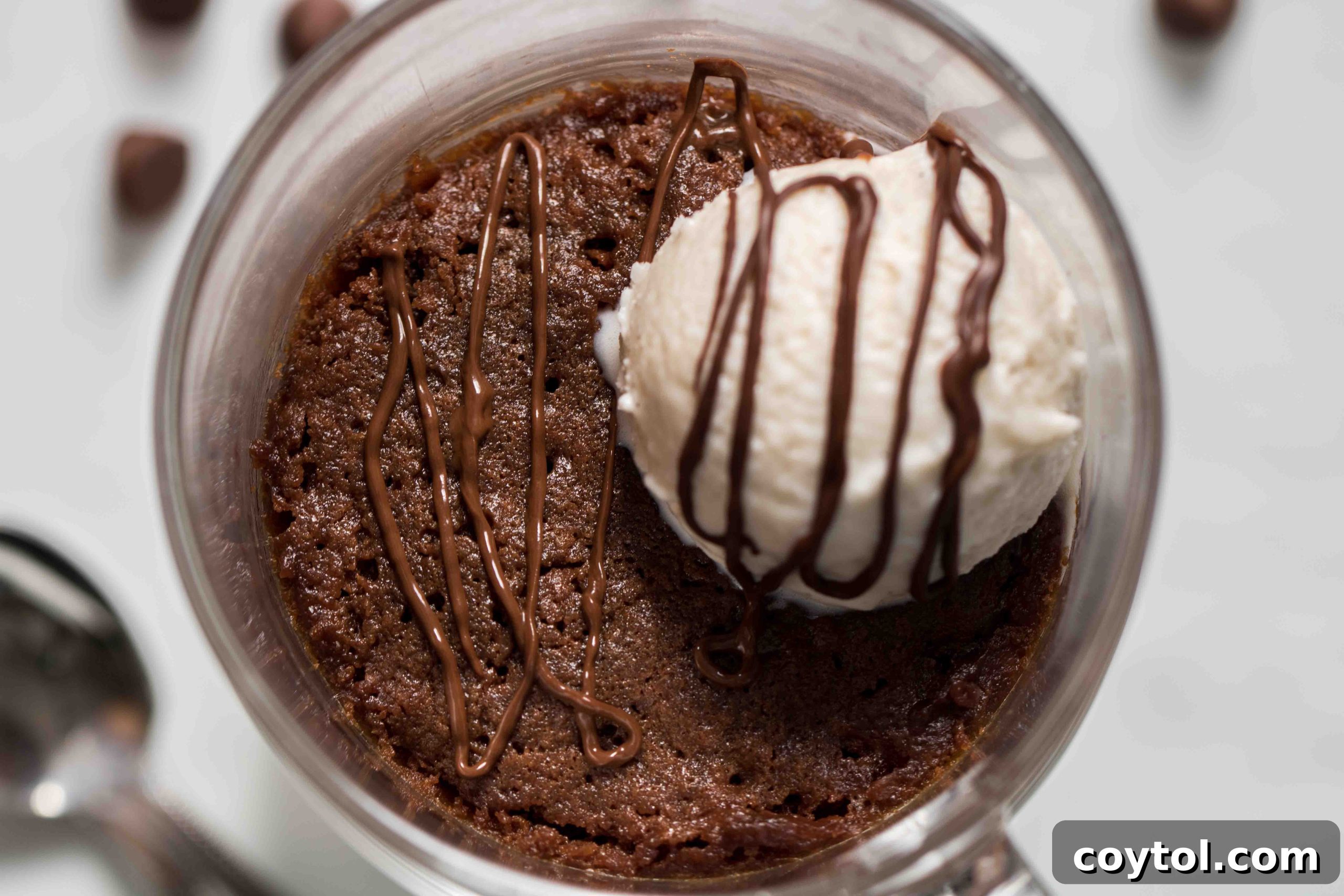 The top of the brownie in a mug recipe with a vanilla bean ice cream scoop