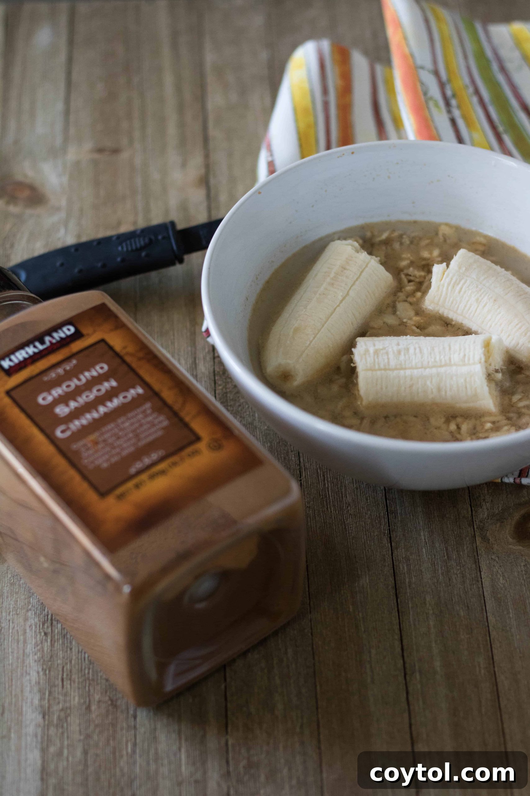 Mashing a ripe banana in a bowl for healthy oatmeal