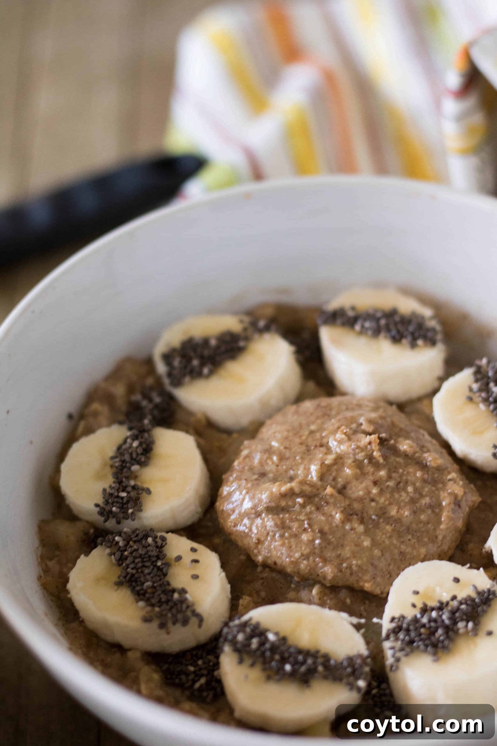 Finished banana oatmeal topped with sliced banana and nut butter