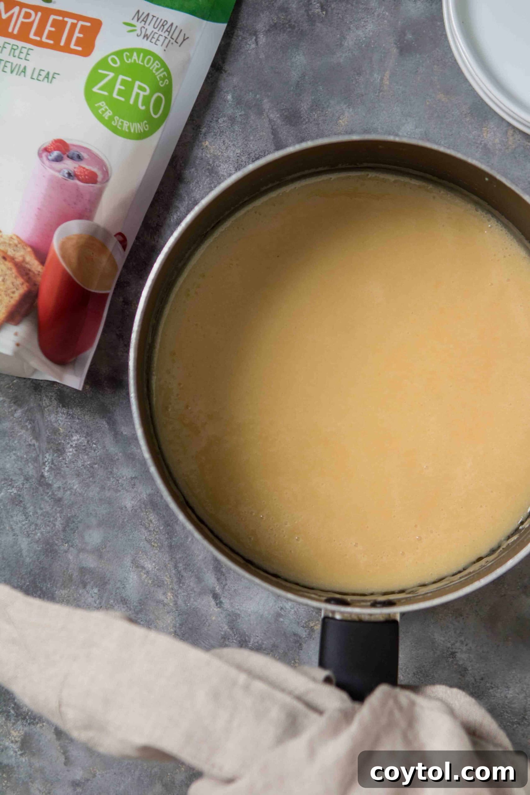 Decadent Small Batch Keto Peanut Butter Fudge 5 Creamy mixture of heavy cream, butter, and Truvia simmering in a saucepan.