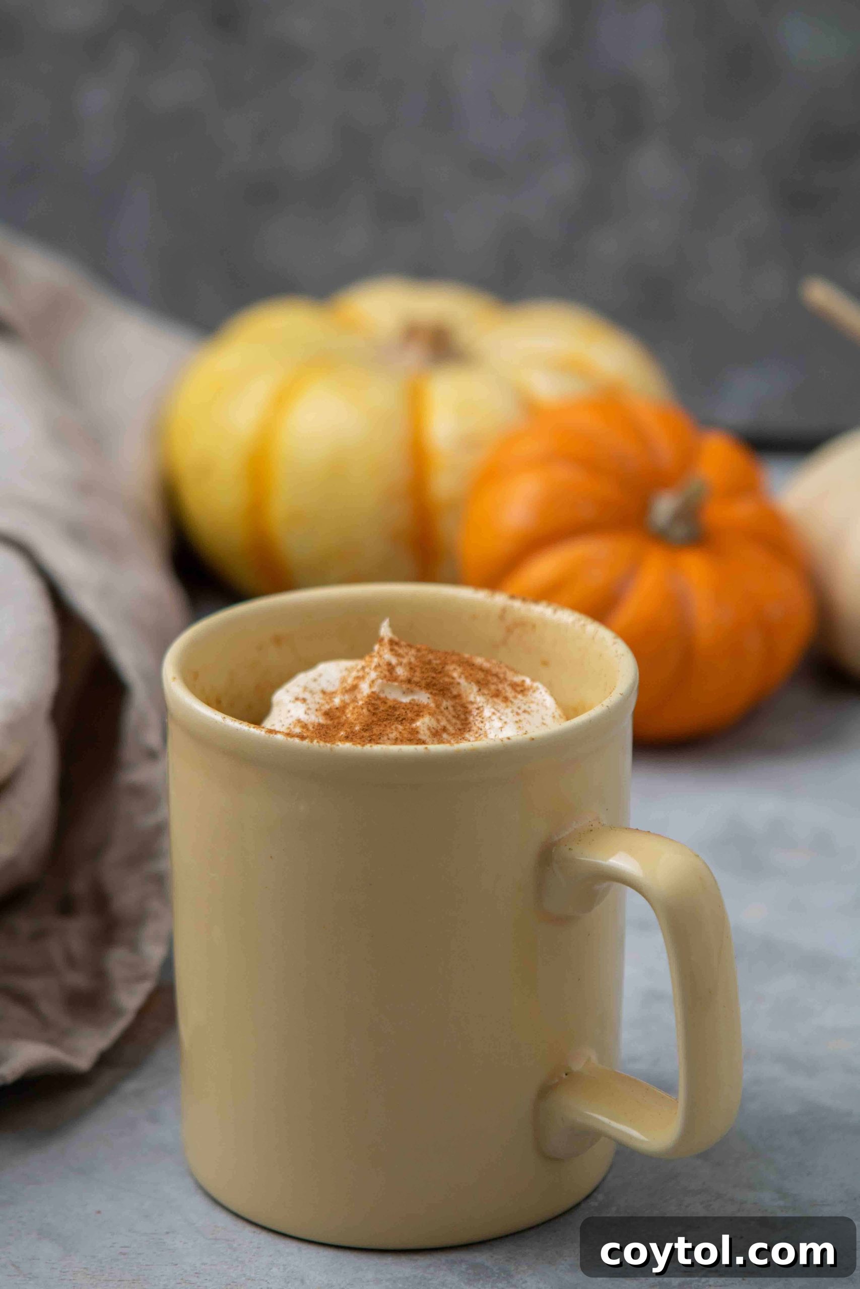 A perfectly baked pumpkin mug cake in a charming yellow mug, ready to be enjoyed as a cozy fall dessert.