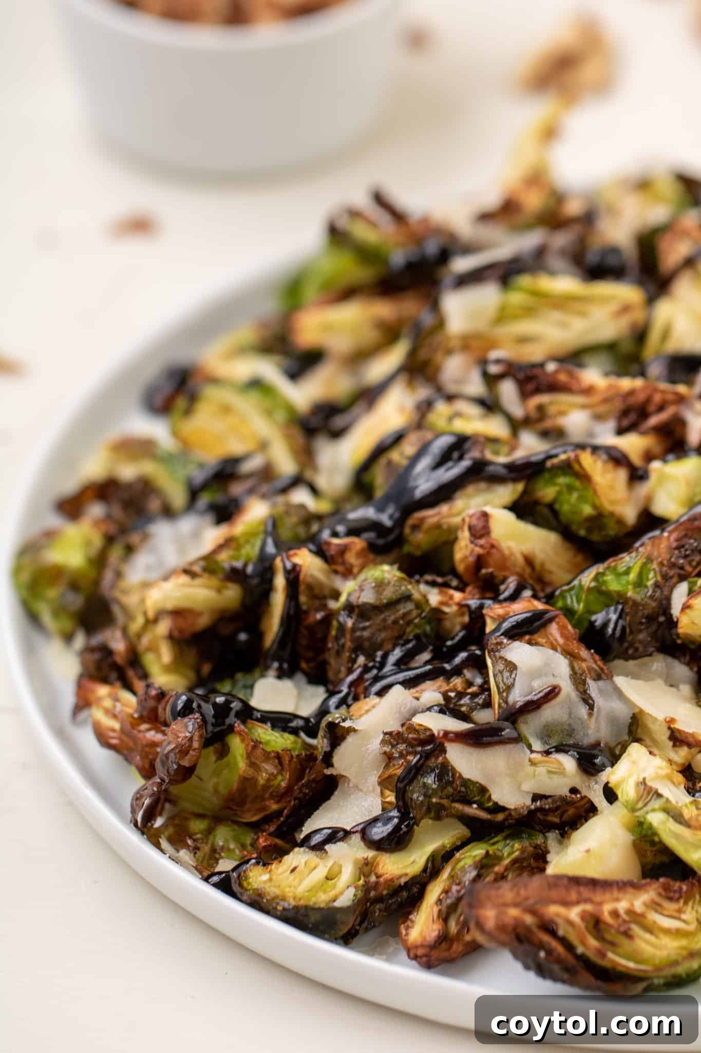Crispy air fryer brussels sprouts with balsamic glaze, walnuts, and parmesan