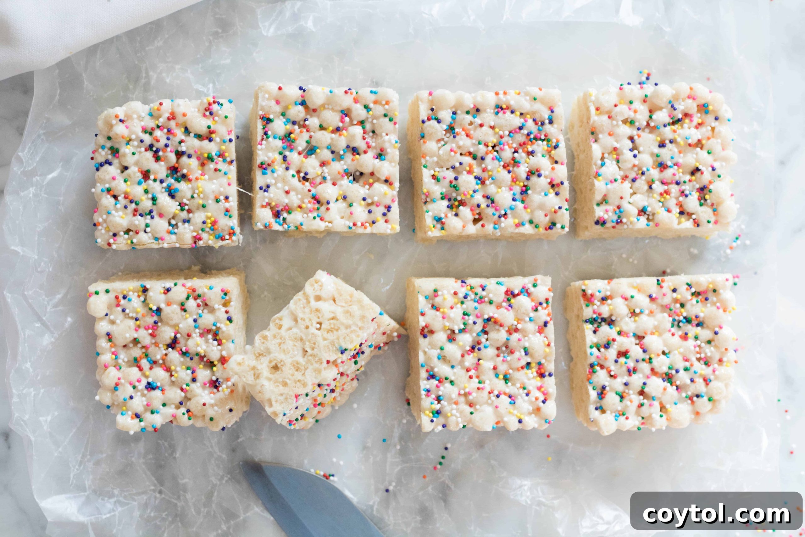 Freshly made Quinoa Pop Krispie Treats on a cutting board, ready to be sliced.