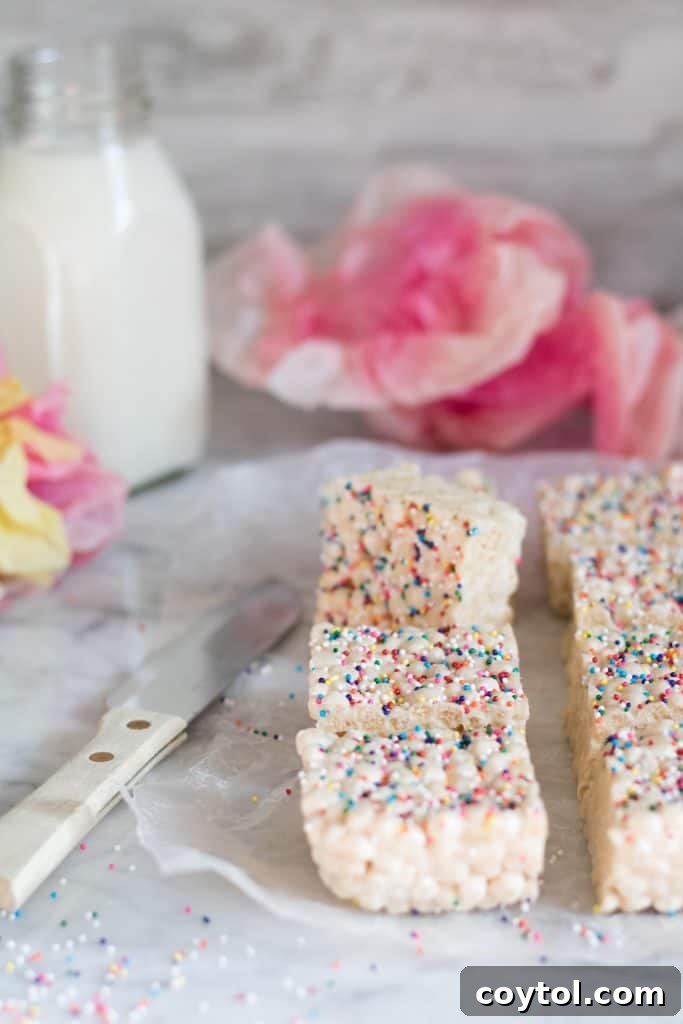 A close-up of the delicious Quinoa Pop Krispie Treats with colorful sprinkles.