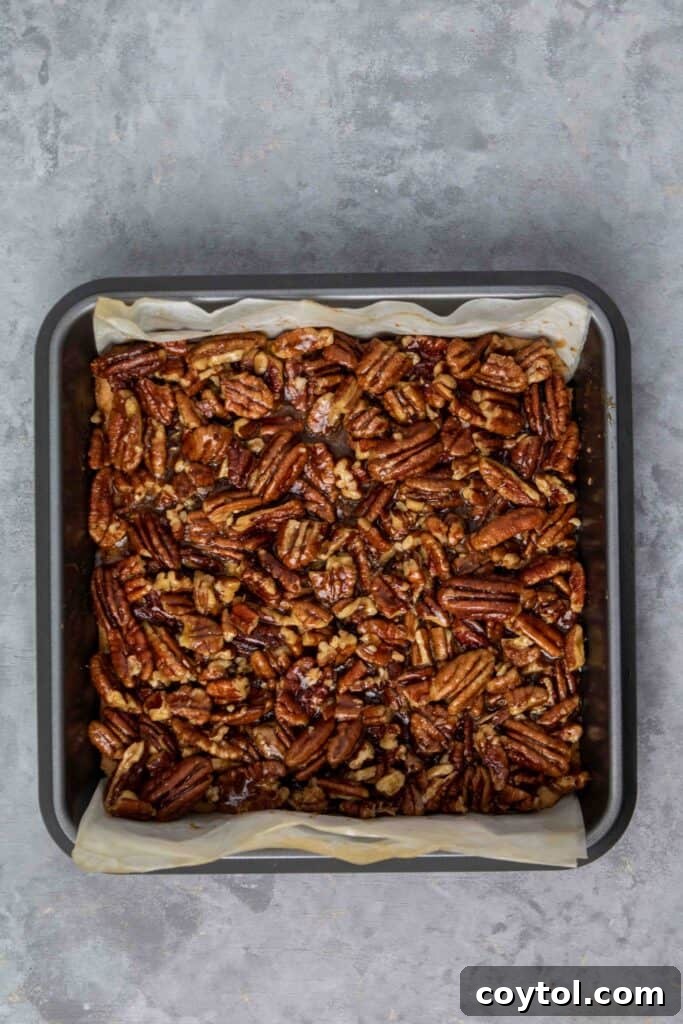 Pecan filling poured over the baked crust.