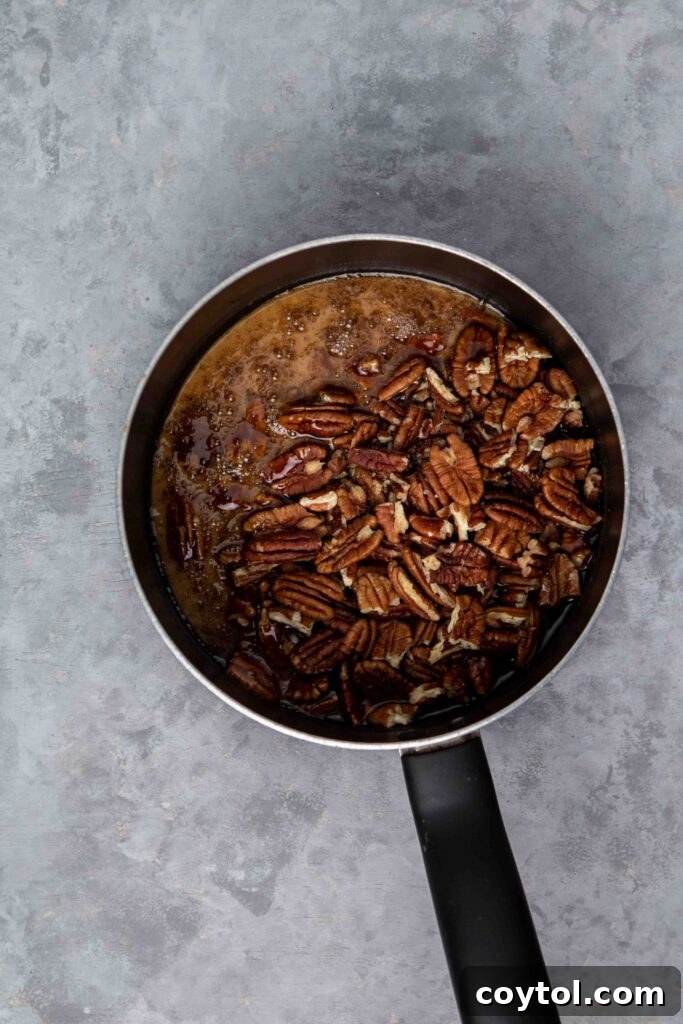 Slicing cooled pecan pie bars into squares.
